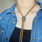 Load image into Gallery viewer, SOLD - Fly Bolo Tie – Orange &amp; Black Cord
