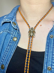 Load image into Gallery viewer, SOLD - Fly Bolo Tie – Orange &amp; Black Cord
