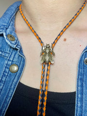 Load image into Gallery viewer, SOLD - Fly Bolo Tie – Orange &amp; Black Cord
