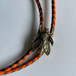 Load image into Gallery viewer, SOLD - Fly Bolo Tie – Orange &amp; Black Cord
